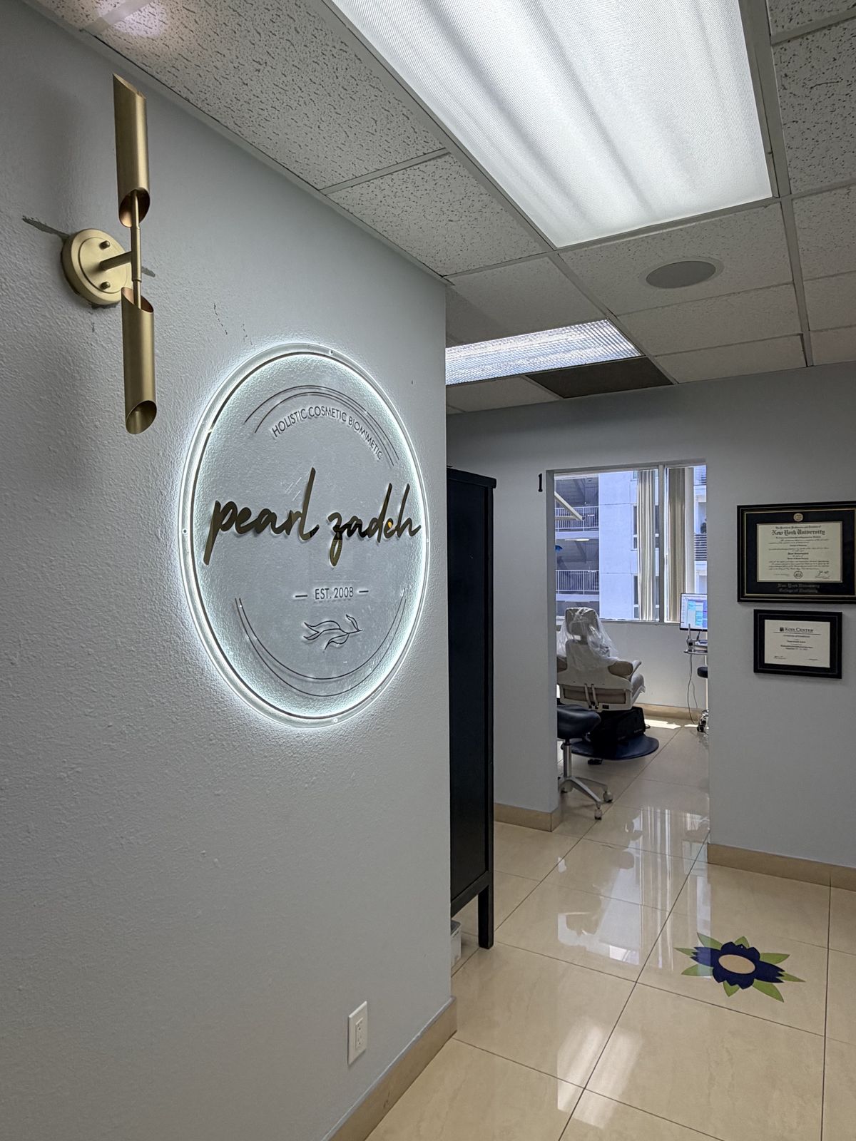 Hallway with the backlit Pearl Zadeh studio sign