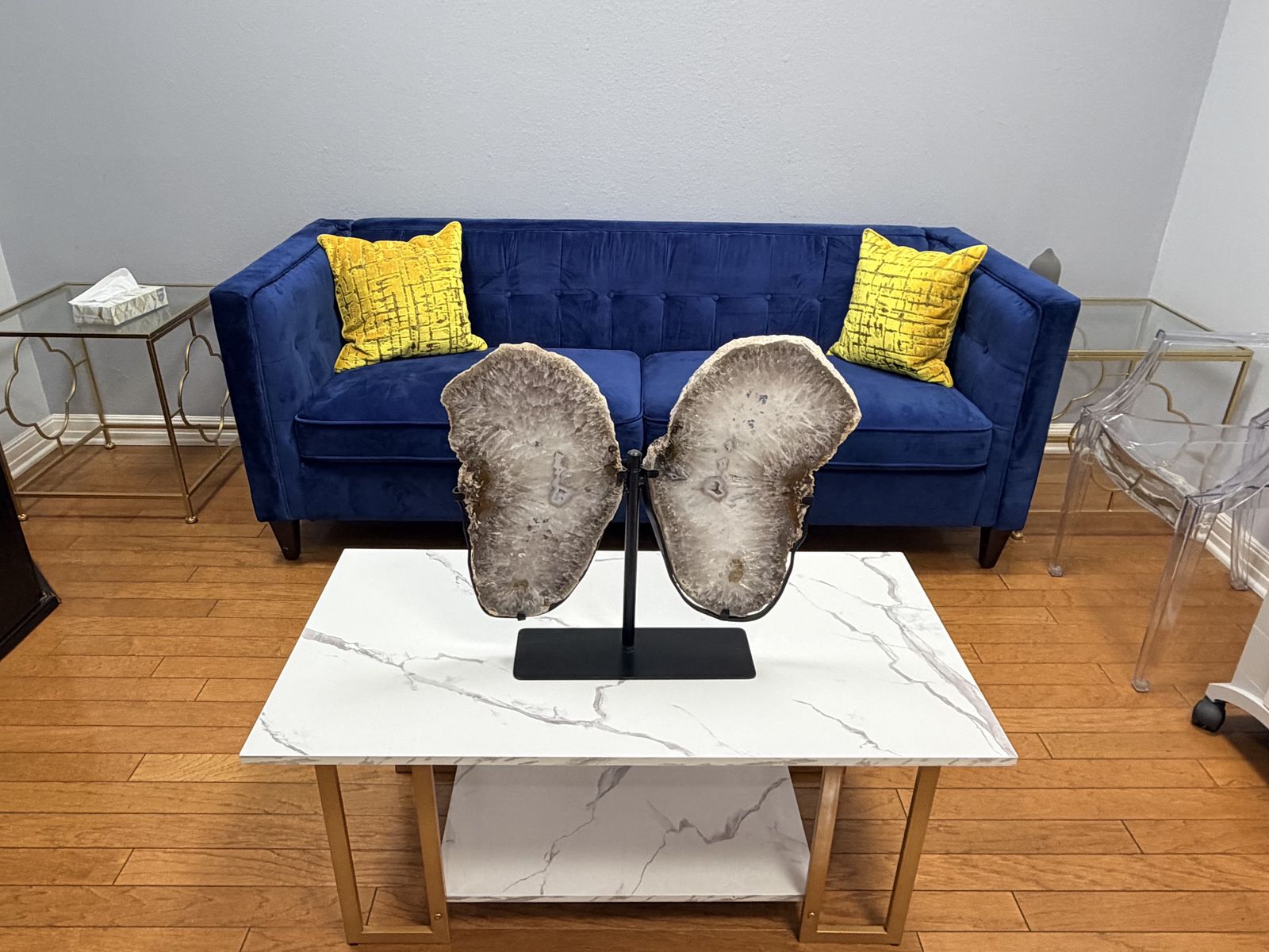 Navy velvet sofa with gold pillows in the patient lounge